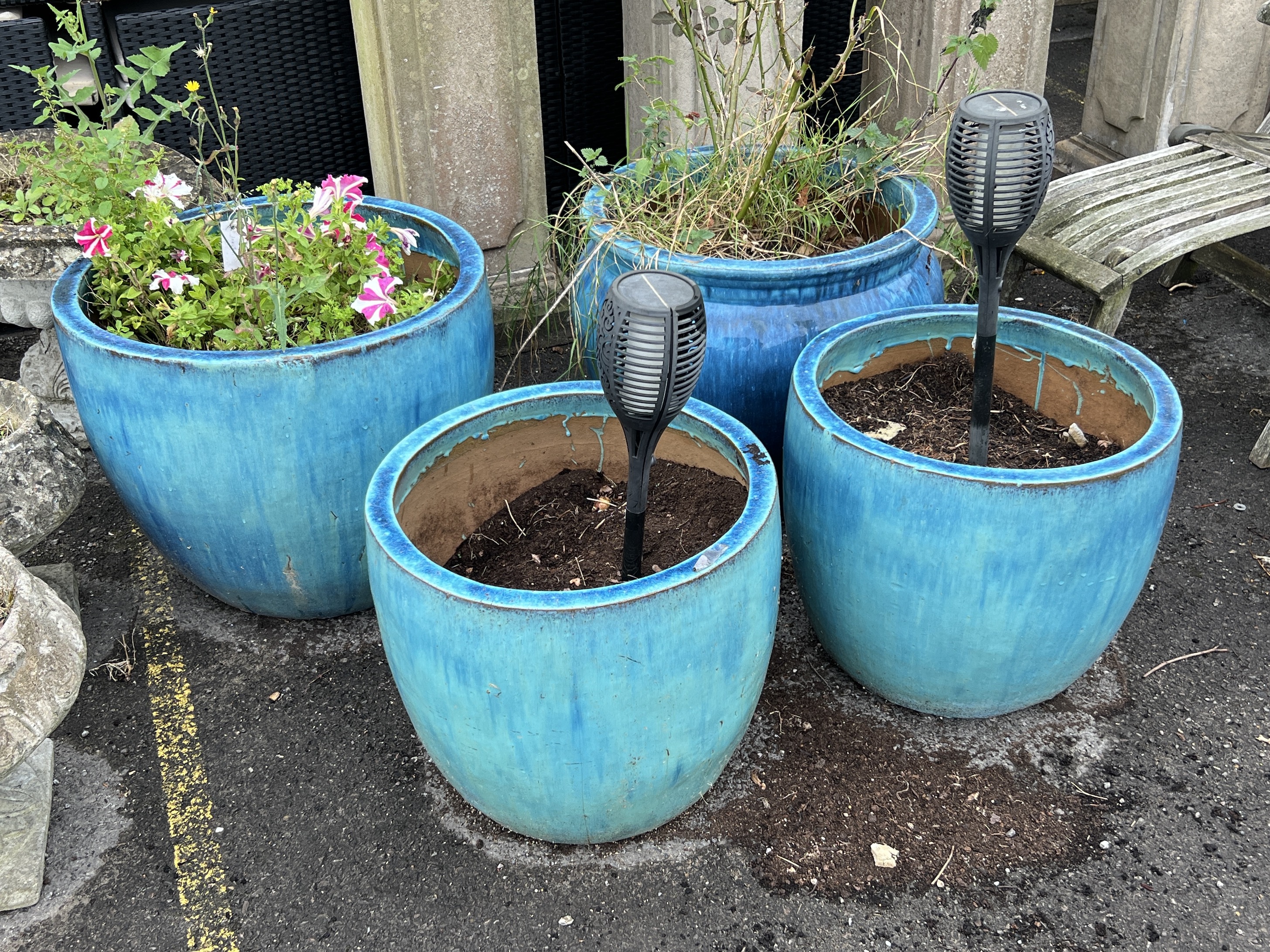 Four large blue glazed circular earthenware garden planters, largest diameter 59cm, height 49cm